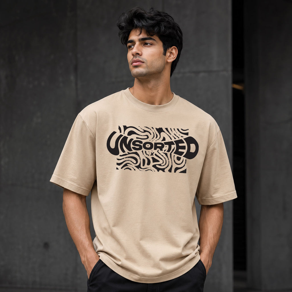 UNSORTED oversized tee in sand — front view with topographic print