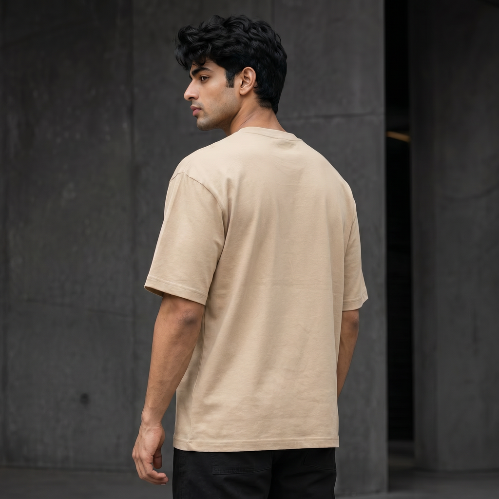 UNSORTED oversized tee in sand — rear three-quarter view