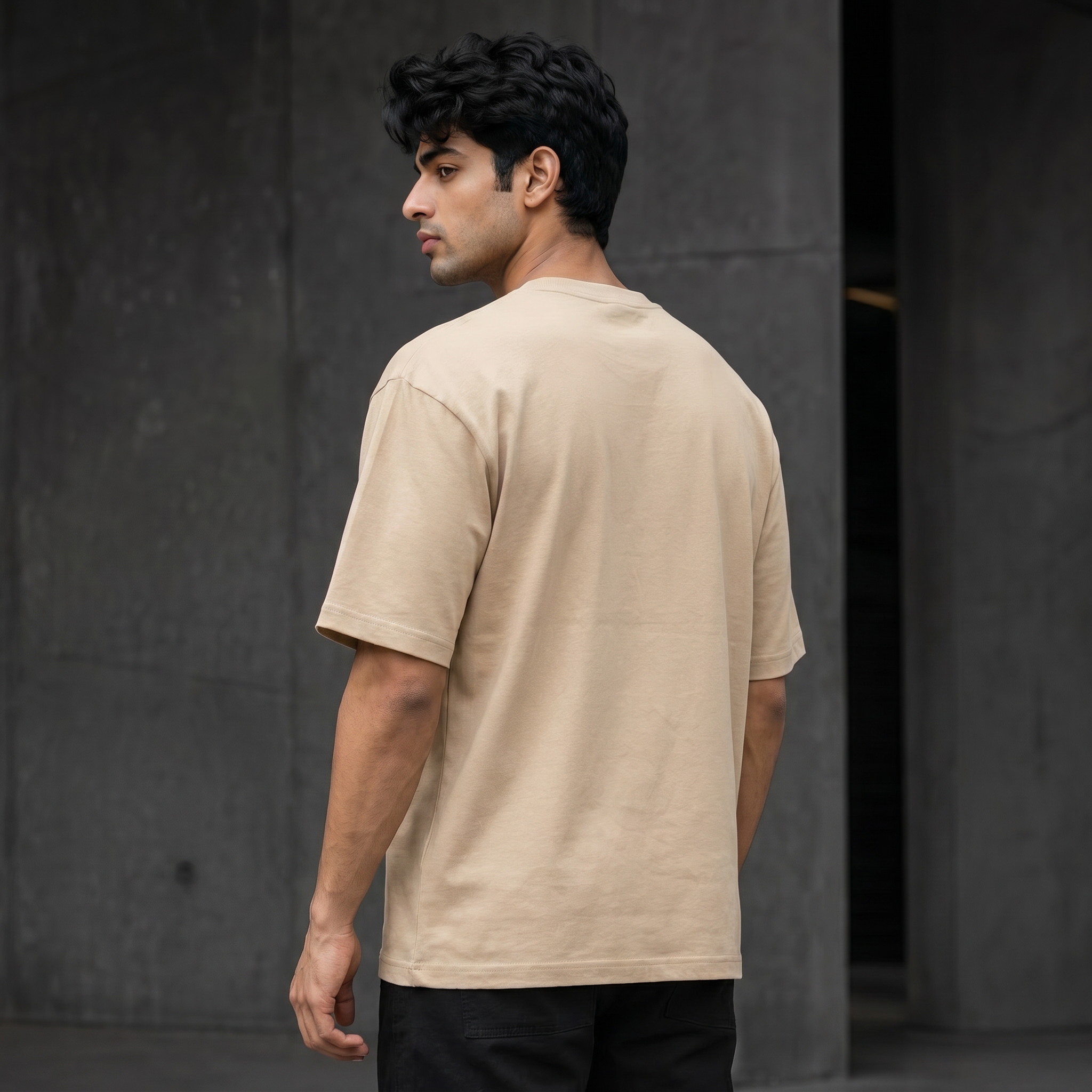UNSORTED oversized tee in sand — rear three-quarter view